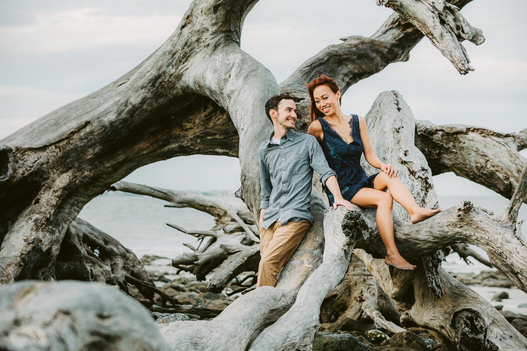 newly engaged couple wears a navy dress and chinos for a jekyll island engagement session shot by nhieu tang | nhieutang.com
