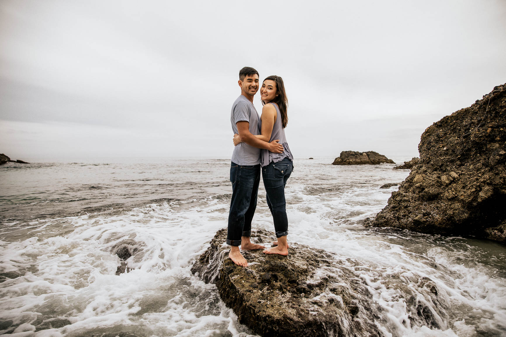 newly engaged couple wears matching outfits on laguna beach for an engagement session shot by nhieu tang | nhieutang.com