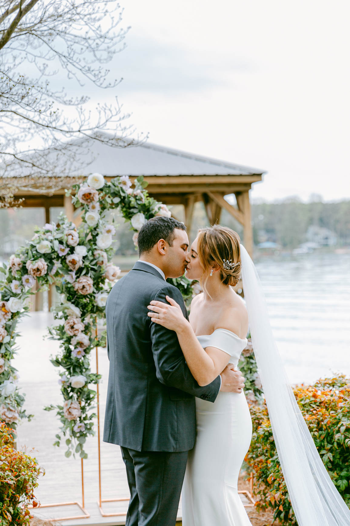 couple first kiss at a lake house elopement in Mooresville, NC