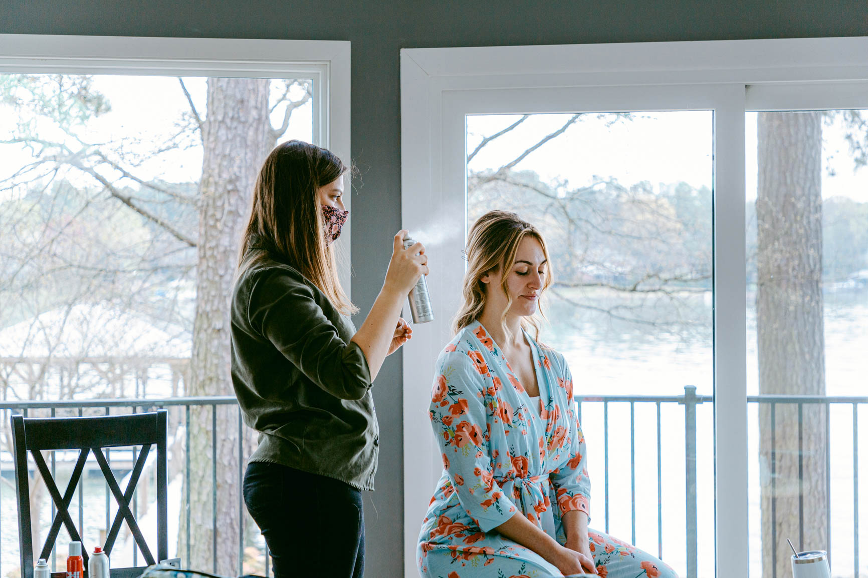 bride wearing a robe getting hair done for an elopement in Mooresville, NC | nhieutang.com