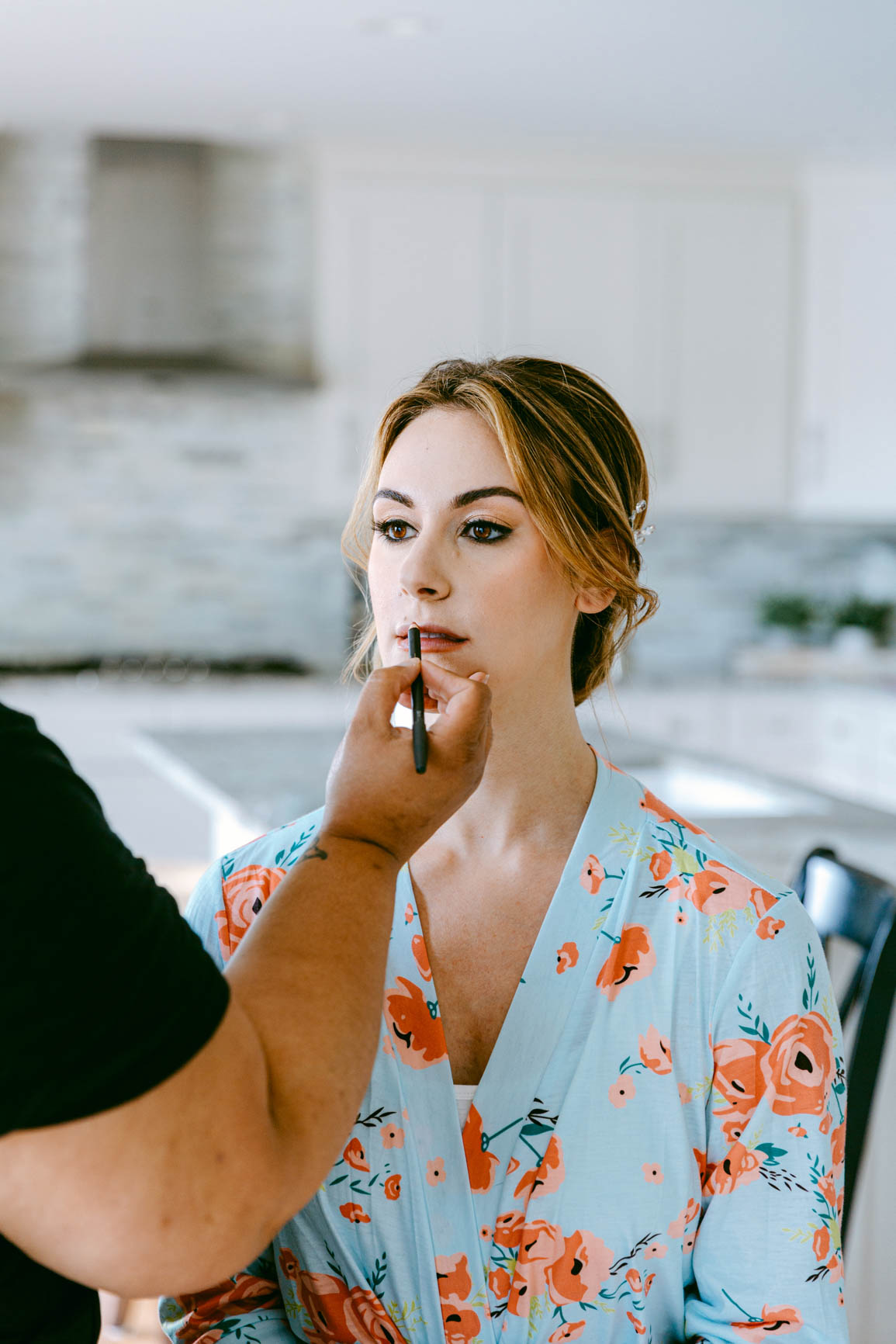 brdie applying lipstick in Mooresville lake house elopement shot by Nhieu Tang Photography | nhieutang.com