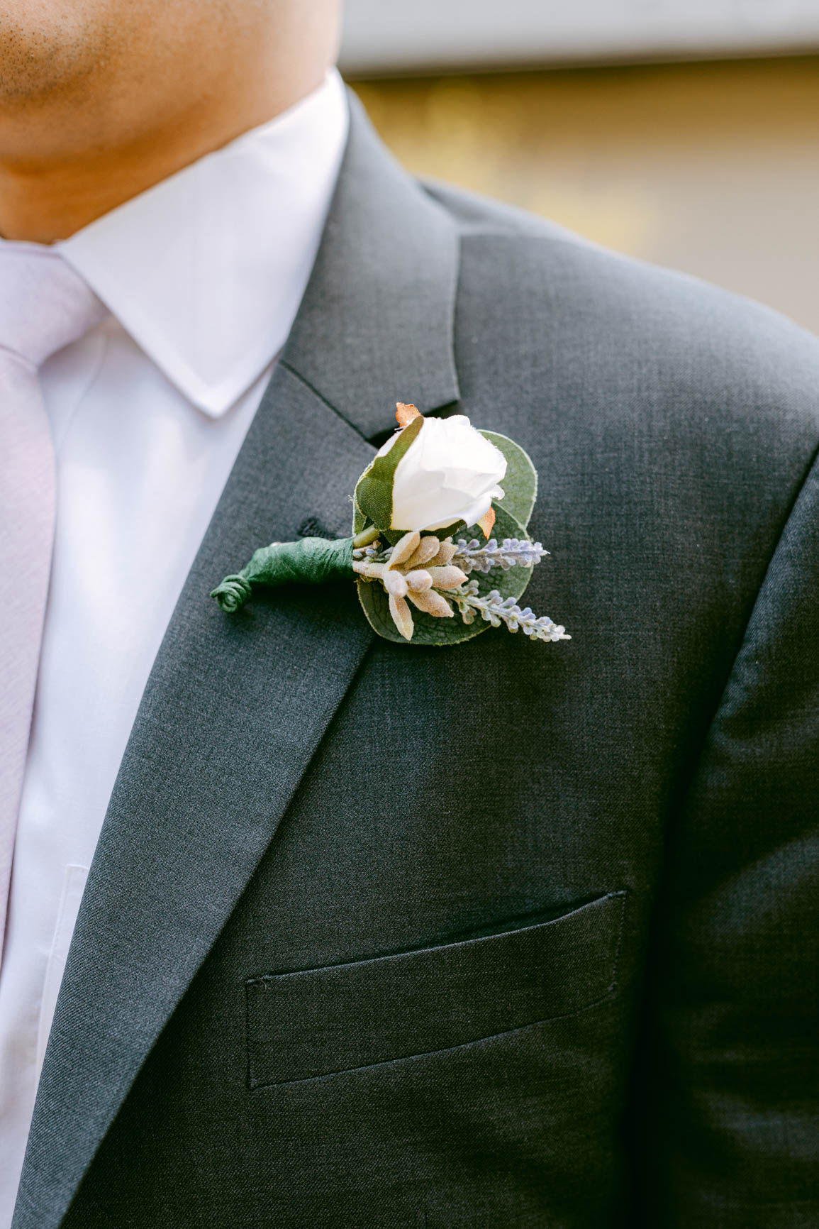 groom boutonniere closeup at a Mooresville, NC lake house shot by Nhieu Tang Photography | nhieutang.com