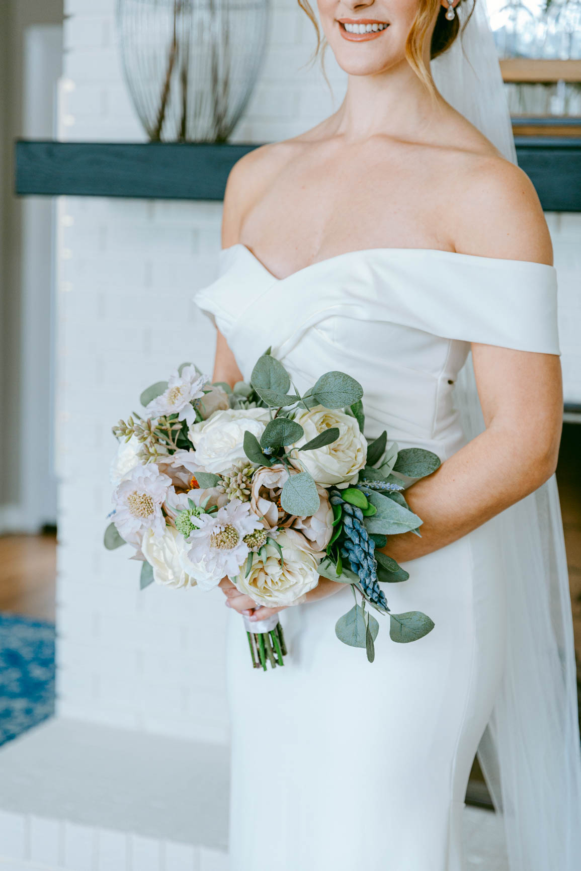 bride holding her bouquet in Mooresville, NC lake house shot by Nhieu Tang Photography | nhieutang.com
