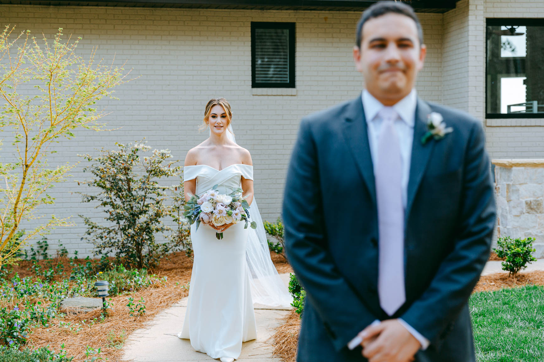 bride walking to groom for a first look in Morrisville lake house shot by Nhieu Tang Photography | nhieutang.com