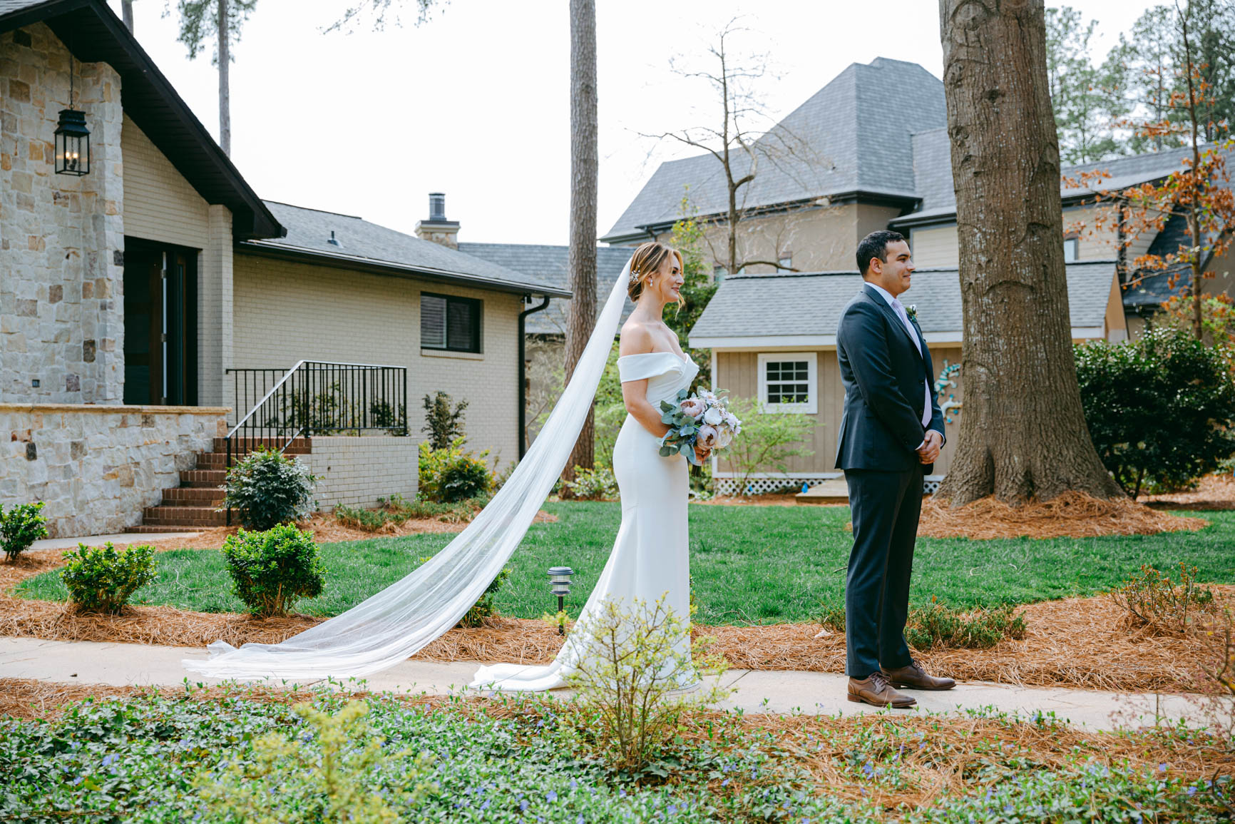 bride walking to groom for a first look in Mooresville, NC lake house shot by Nhieu Tang Photography | nhieutang.com