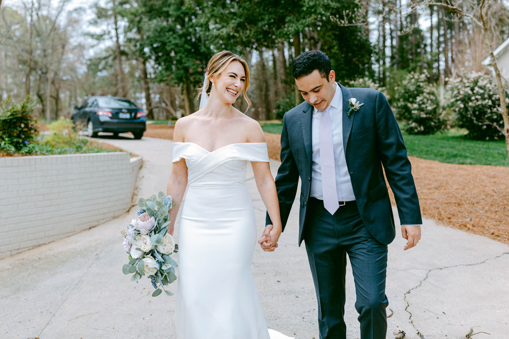 couple holding hand walking to ceremony in Mooresville, NC shot by Nhieu Tang Photography | nhieutang.com
