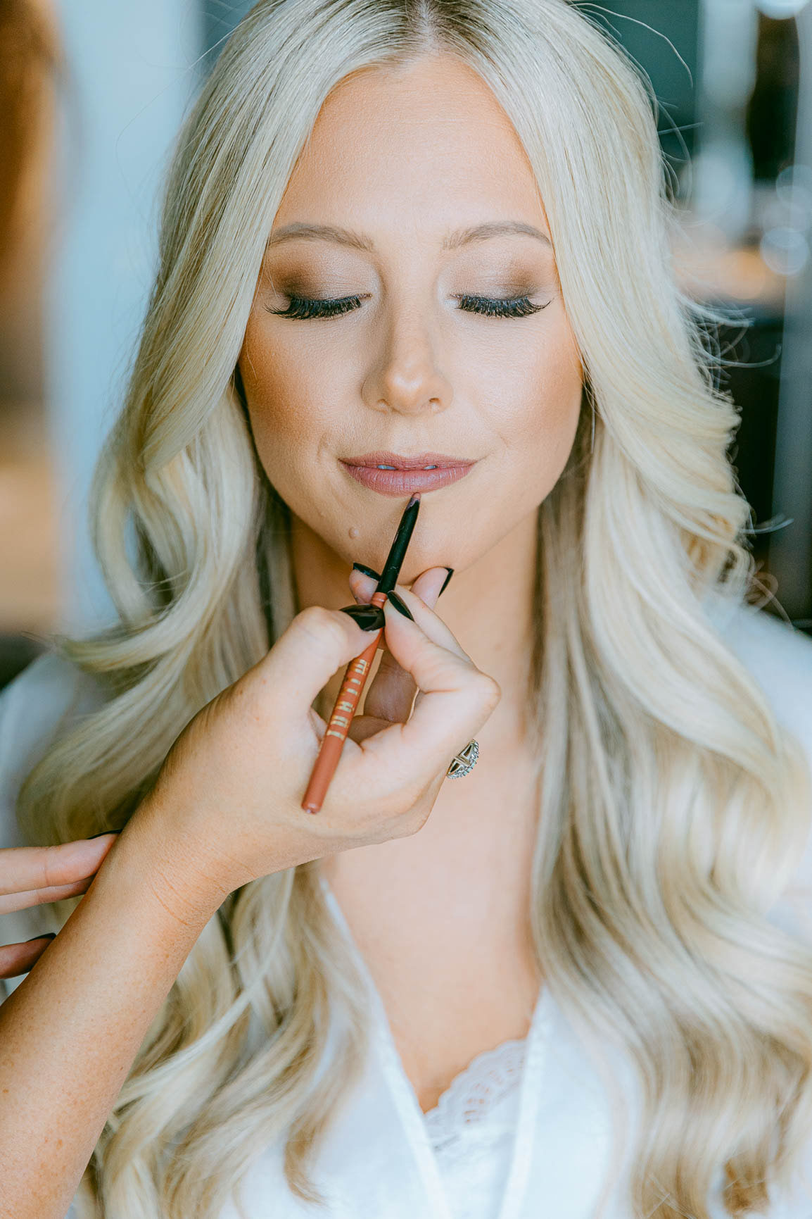 Bride wedding getting makeup done in uptown Charlotte shot by Nhieu Tang Photography | nhieutang.com