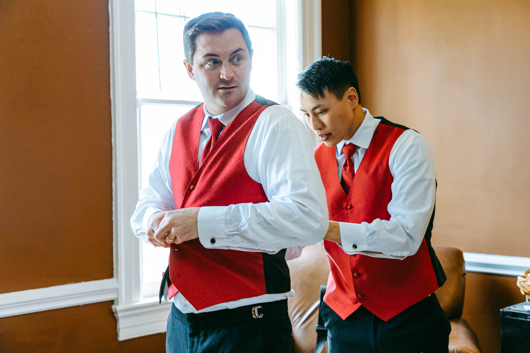 groomsmen putting on vest at Separk Mansion in Gastonia NC shot by Nhieu Tang Photography | nhieutang.com
