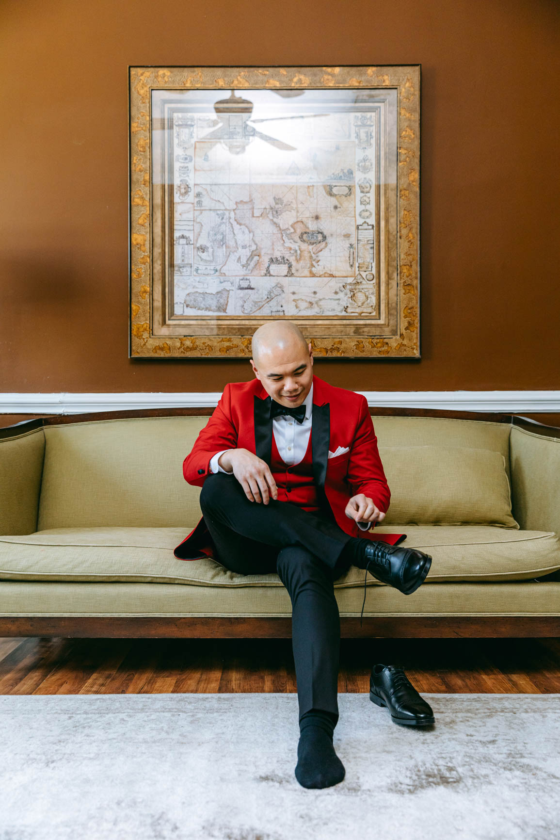 groom getting shoes on at Separk Mansion in Gastonia NC shot by Nhieu Tang Photography | nhieutang.com