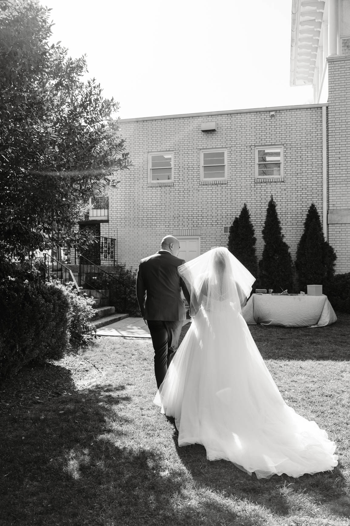 bride and groom recessing at Separk Mansion in Gastonia NC shot by Nhieu Tang Photography | nhieutang.com