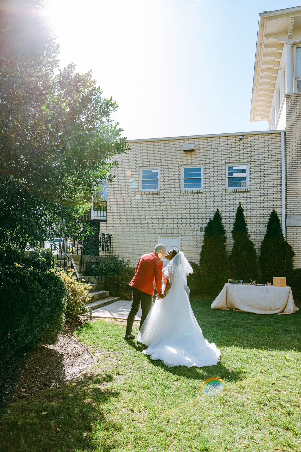bride and groom kisses during recessing at Separk Mansion in Gastonia NC shot by Nhieu Tang Photography | nhieutang.com