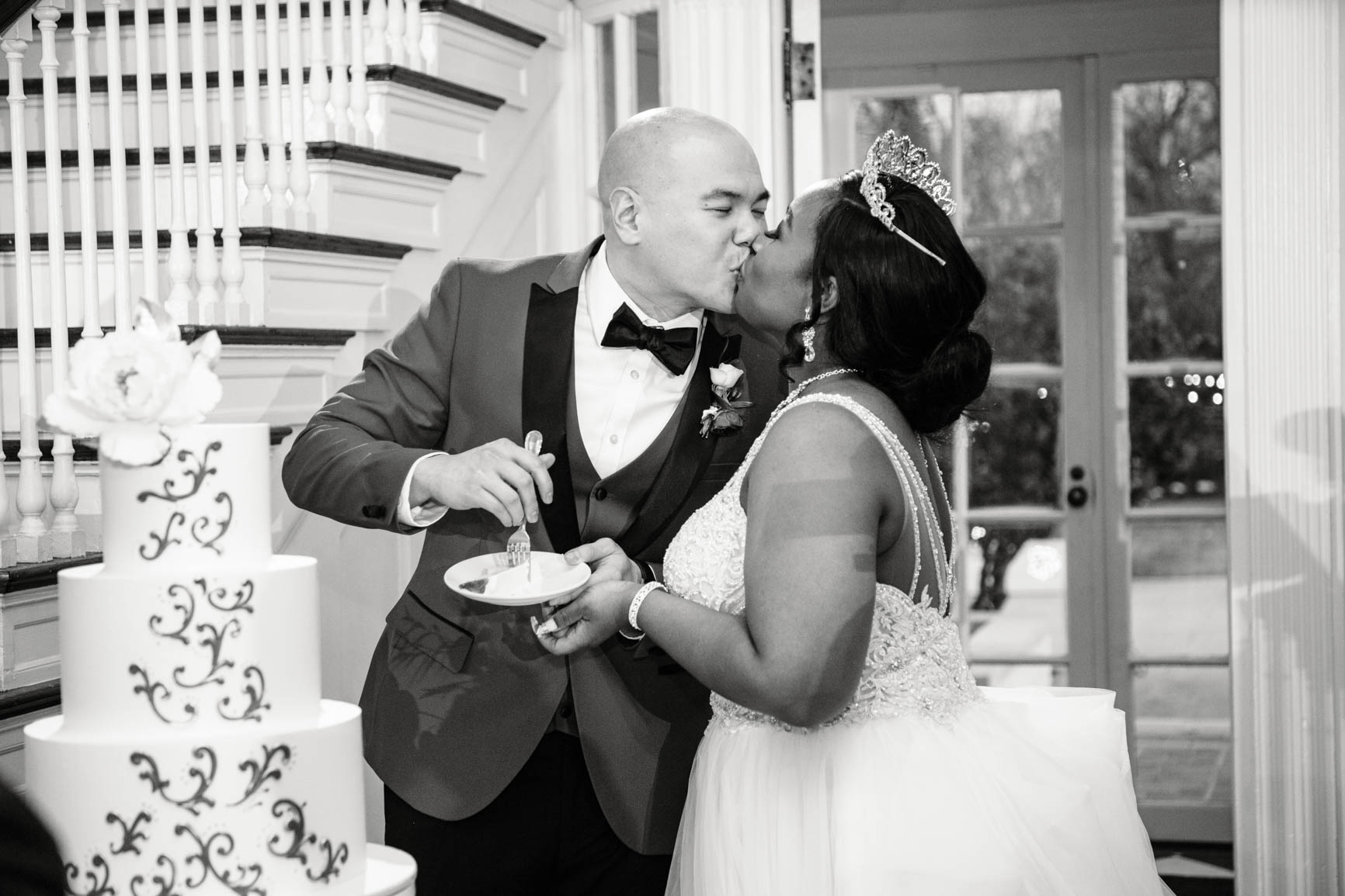 kiss during cake cutting at Separk Mansion in Gastonia NC shot by Nhieu Tang Photography | nhieutang.com